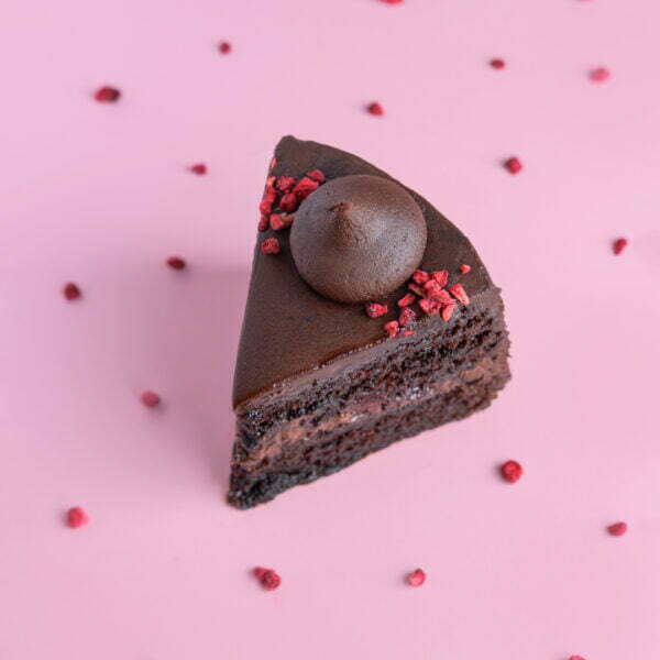 A slice of vegan chocolate raspberry cake